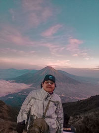 Portrait of man standing against mountain