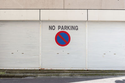 Road sign against wall