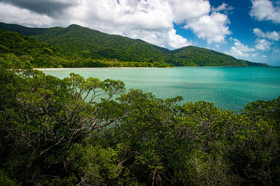 Scenic view of sea and mountains against sky