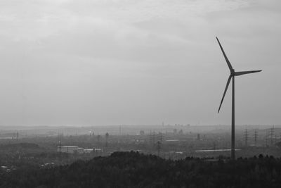 Scenic view of wind turbine in landscape against sky