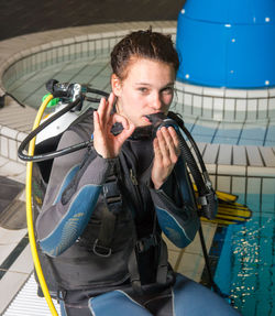 Full length of woman scuba diving in swimming pool