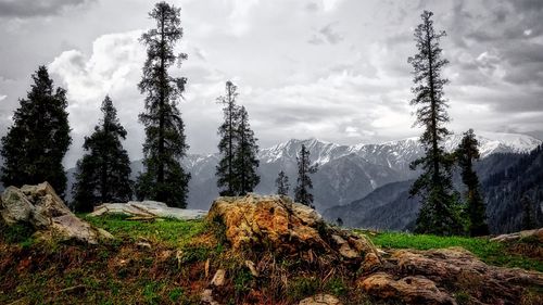 Scenic view of mountains against cloudy sky