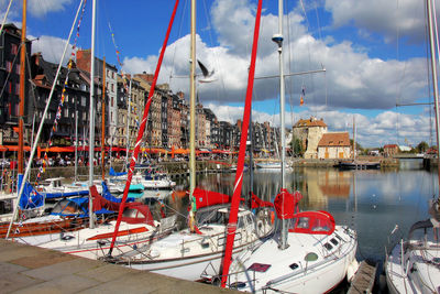 Boats moored in sea against sky
