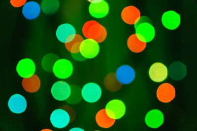 Abstract blurred lights on background in blue, green, orange colors. - christmas celebration concept