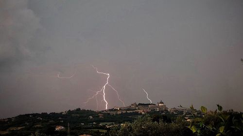 Low angle view of lightning against sky at night