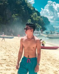 Young man standing on beach