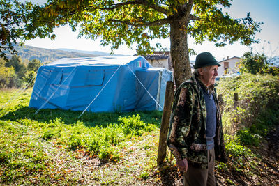 Side view of man standing by plants