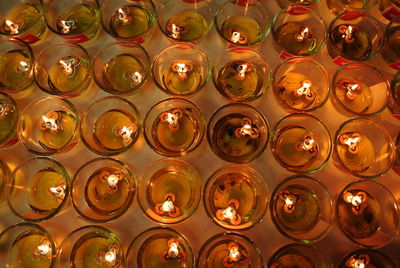 High angle view of illuminated candles on table