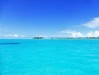 Scenic view of sea against blue sky