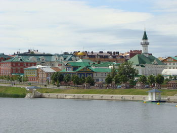 Buildings in city against cloudy sky