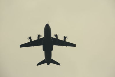 Low angle view of airplane flying against clear sky