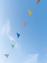 Low angle view of flags against sky