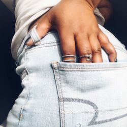 Close-up midsection of woman with hand in pocket