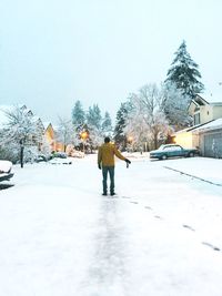 Person walking on snow covered landscape