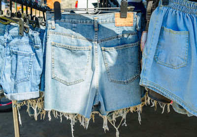 Close-up of clothes hanging on blue for sale