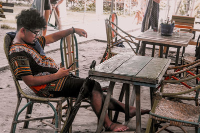 Man sitting on chair at table