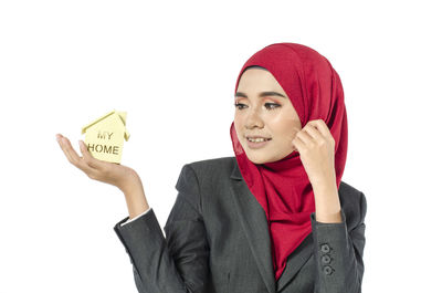 Portrait of a smiling young woman against white background