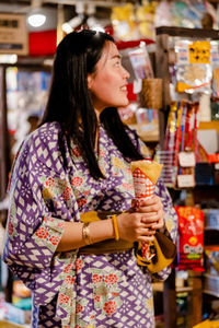 Woman holding ice cream in store