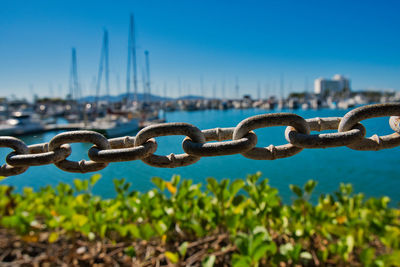 Close-up of chain against blue sky