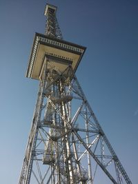 Low angle view of tower against blue sky