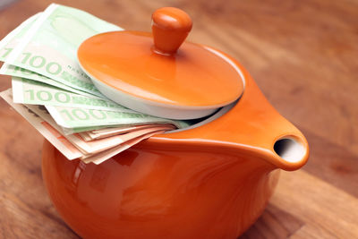 Close-up of currency in cup on table