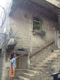 Woman standing on steps of house