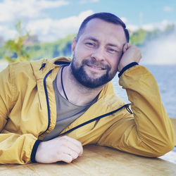 Portrait of smiling man sitting outdoors