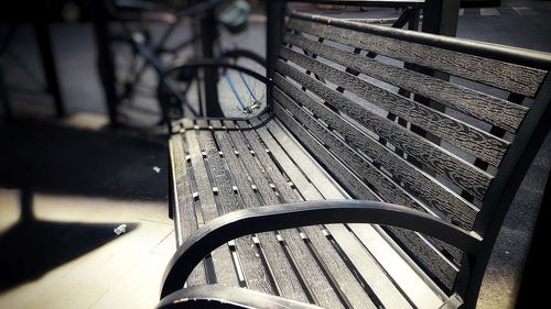 Close-up of empty bench in park