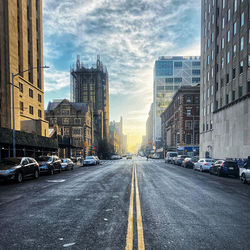 City street and buildings against sky