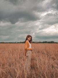 Woman standing on land against sky