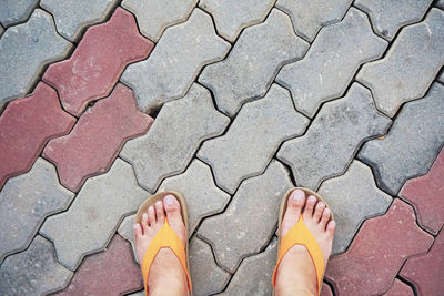 Low section of man standing on footpath