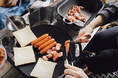 Cropped hand of woman preparing food