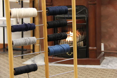 Colorful spools against fireplace