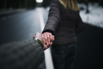 Close-up of couple holding hands