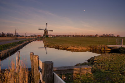 Scenic view of river against sky during sunset