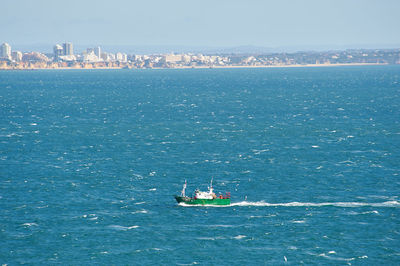 Scenic view of sea and buildings against sky