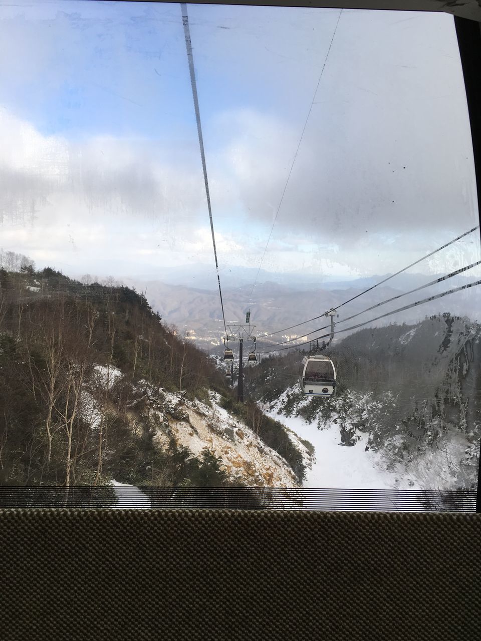 transportation, sky, power line, electricity pylon, mode of transport, cloud - sky, power supply, weather, connection, electricity, cable, reflection, railroad track, glass - material, day, built structure, public transportation, window, snow, rail transportation