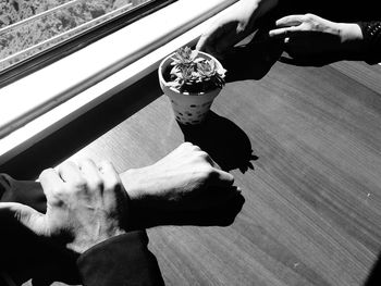 High angle view of man holding ice cream on table