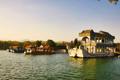 Boats in river against buildings