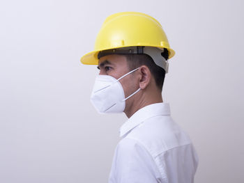 Portrait of man wearing hat against white background