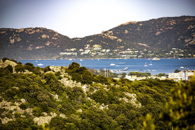 Scenic view of sea and mountains against sky