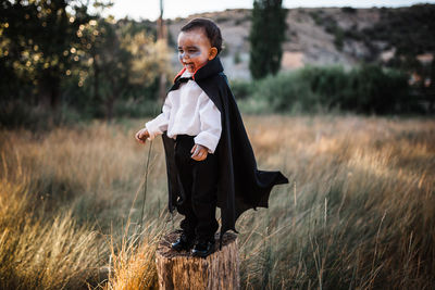 Full length of boy standing on field