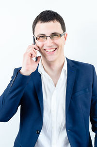 Portrait of smiling young man using mobile phone