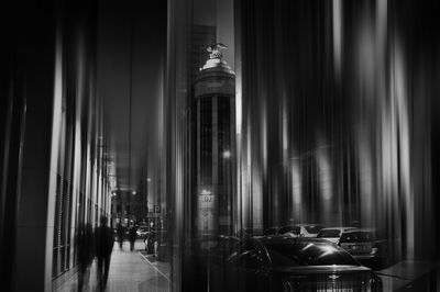 Illuminated building seen through glass window at night