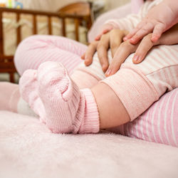 Mather holding babys hands, concept baby at home, close up