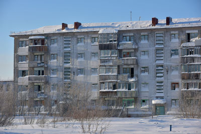 Low angle view of building against sky during winter