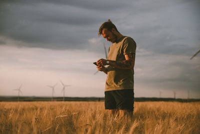 Man standing on field against sky