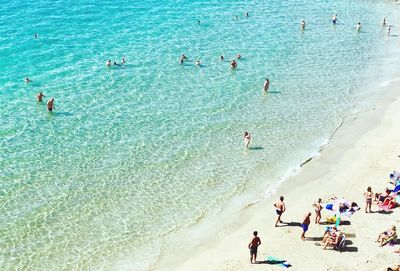 High angle view of people enjoying at beach