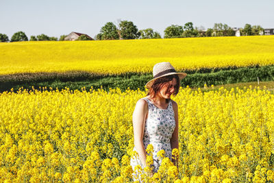 Rear view of woman standing in field