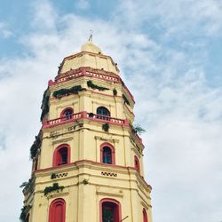 Low angle view of bell tower against cloudy sky